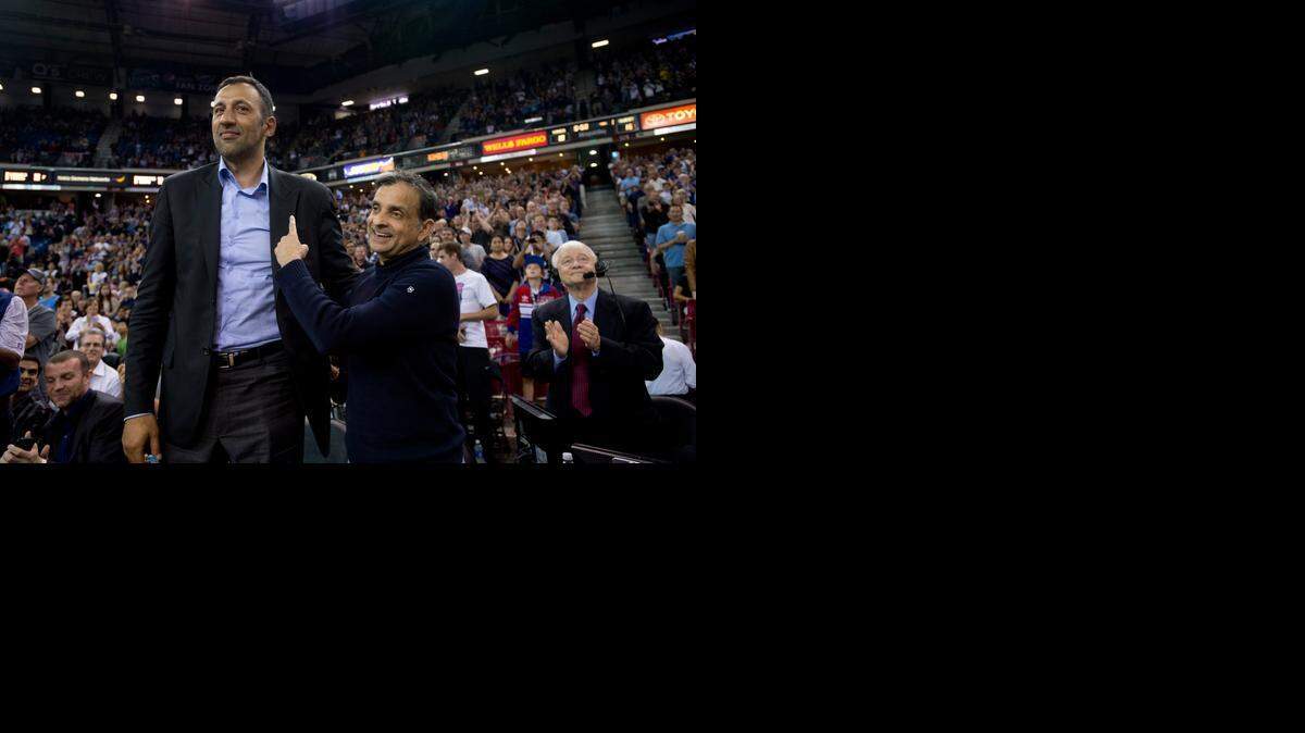 
Former Kings center Vlade Divac, left, stands with Kings majority owner Vivek Ranadive after being introduced to the crowd last season at Sleep Train Arena.
