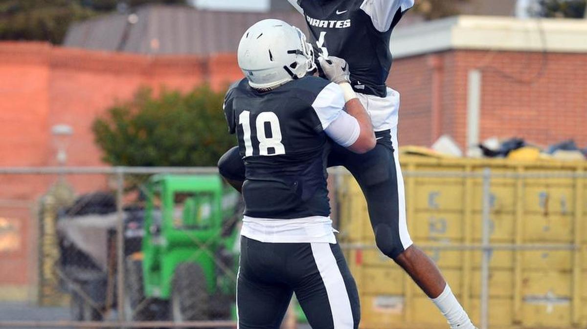 MJC's Aaron Paschini (18) celebrates with Michael Thompson (6) after Thompson scored during a game between Modesto Junior College and American River College at Modesto Junior College in Modesto, Calif., on Sept. 9, 2017. American River won the game 55-49 in double overtime.