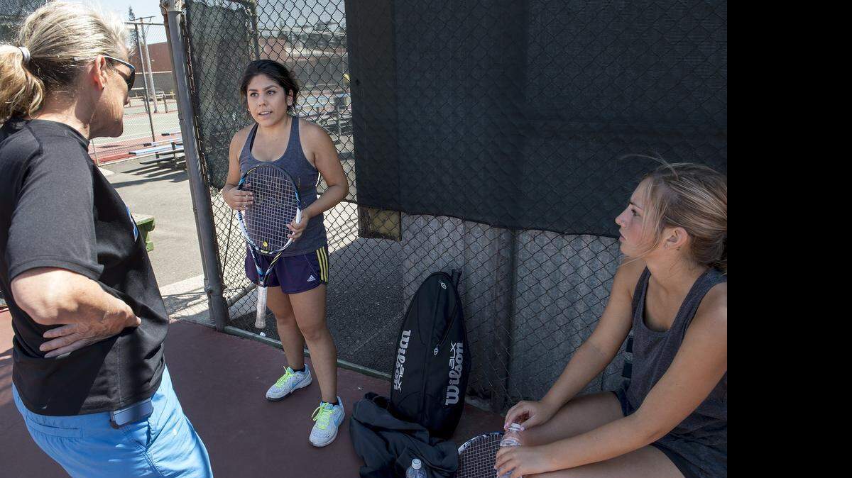 
No. 1 singles player Vanessa Teves, middle, talks with coach Milan Motroni, left, and teammate No. 3 player Parker Pilati, right, during practice at Modesto Junior College on Thursday.
