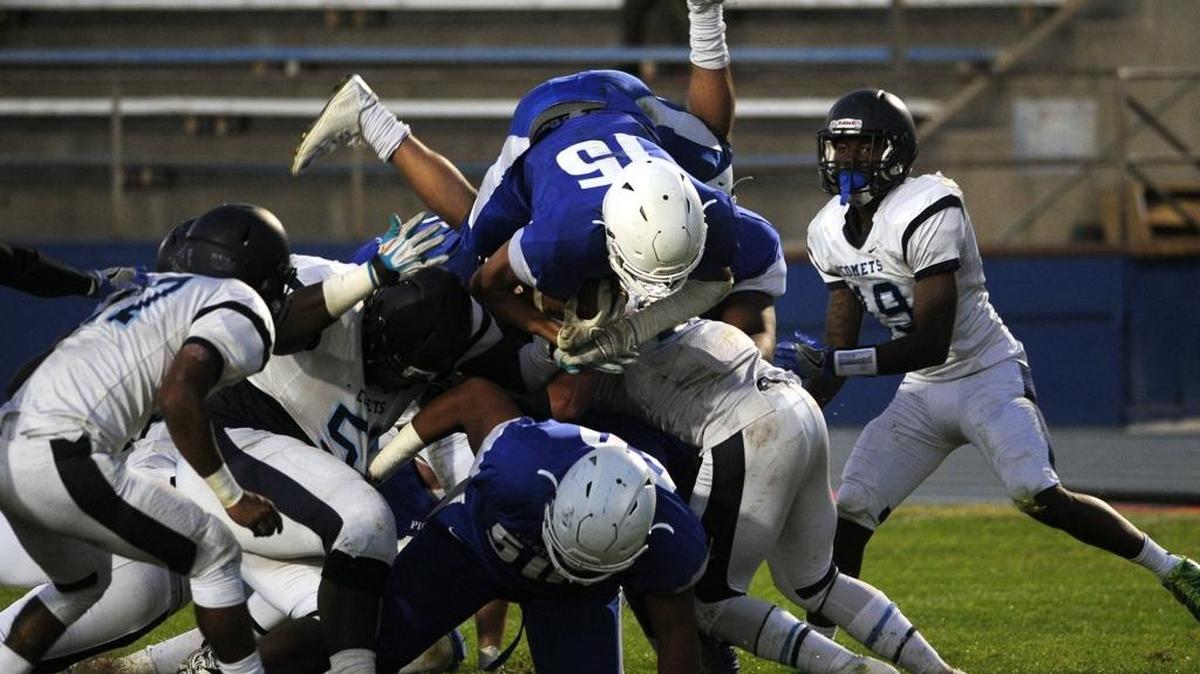 Modesto Junior College running back Devan Bass (15), showing leaping over defenders and into the end zone for a TD during the Pirates’ game against Contra Costa College in Modesto on Sept. 23, 2017, rushed for 187 yards in Saturday’s win over College of the Sequoias in Visalia.