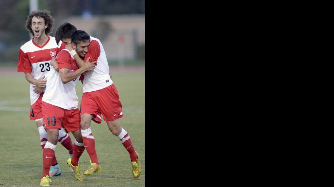 
Cal State Stanislaus’ Christian Madrigal, center, is hugged by teammate Jose Barajas after scoring Thursday.


