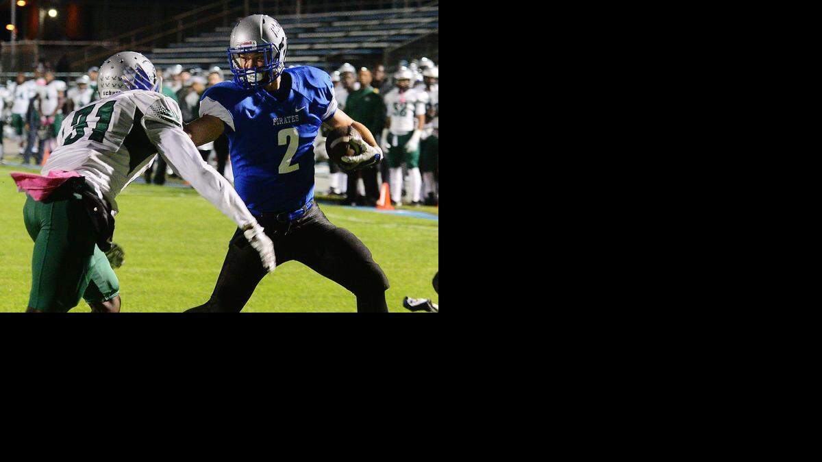 
MJC wide receiver Chris Souza pushes past Michael Adams for the Pirates’ first touchdown, a 1-yard run in the second quarter. 
