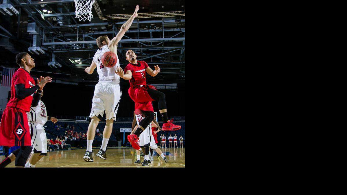 Shey<137,,>✔<137> Mataele<137,,>✔<137> (2) of Cal State Stanislaus passes to Wes Bartole<137>✔<137> behind Chico State’s Tanner Giddings during the Warriors’ 72-60 loss on Friday night at Stockton Arena.