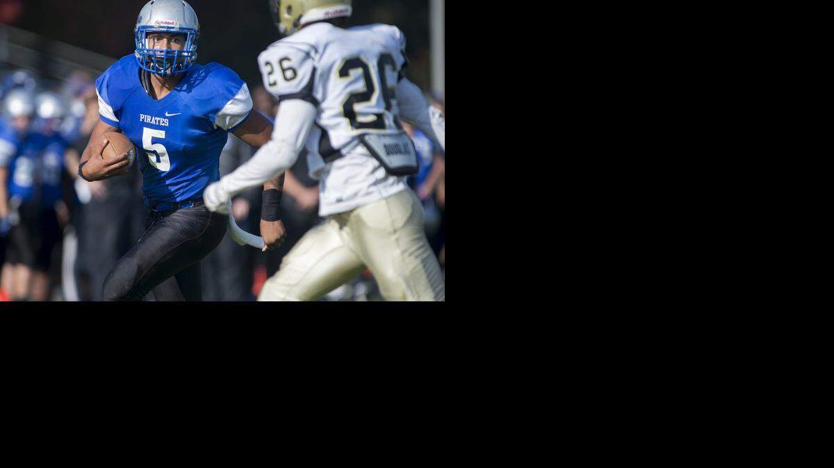 
Modesto's Anthony Coda runs for a first quarter touchdown as Delta's Ian Montazem defends during the Valley Conference game at Modesto Junior College in Modesto, Calif., on Saturday, November. 15, 2014.

