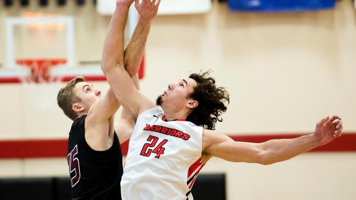 Stanislaus' Kyle Gouvela and Chico's Tanner Giddings at the start of the CCAA game at California State University, Stanislaus in Turlock, Calif., on Wednesday, Dec. 9, 2015.