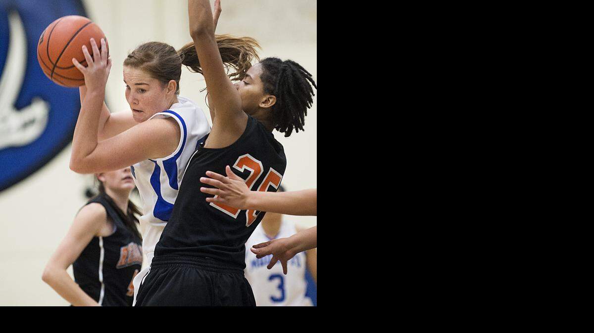 
Modesto JC forward Brianna McGinness attacks the basket as Reedley College's Markeshia Evans defends during Thursday night's game at Modesto Junior College in Modesto, Calif., November, 20, 2014. The Pirates fell to the Tigers 56-43.
