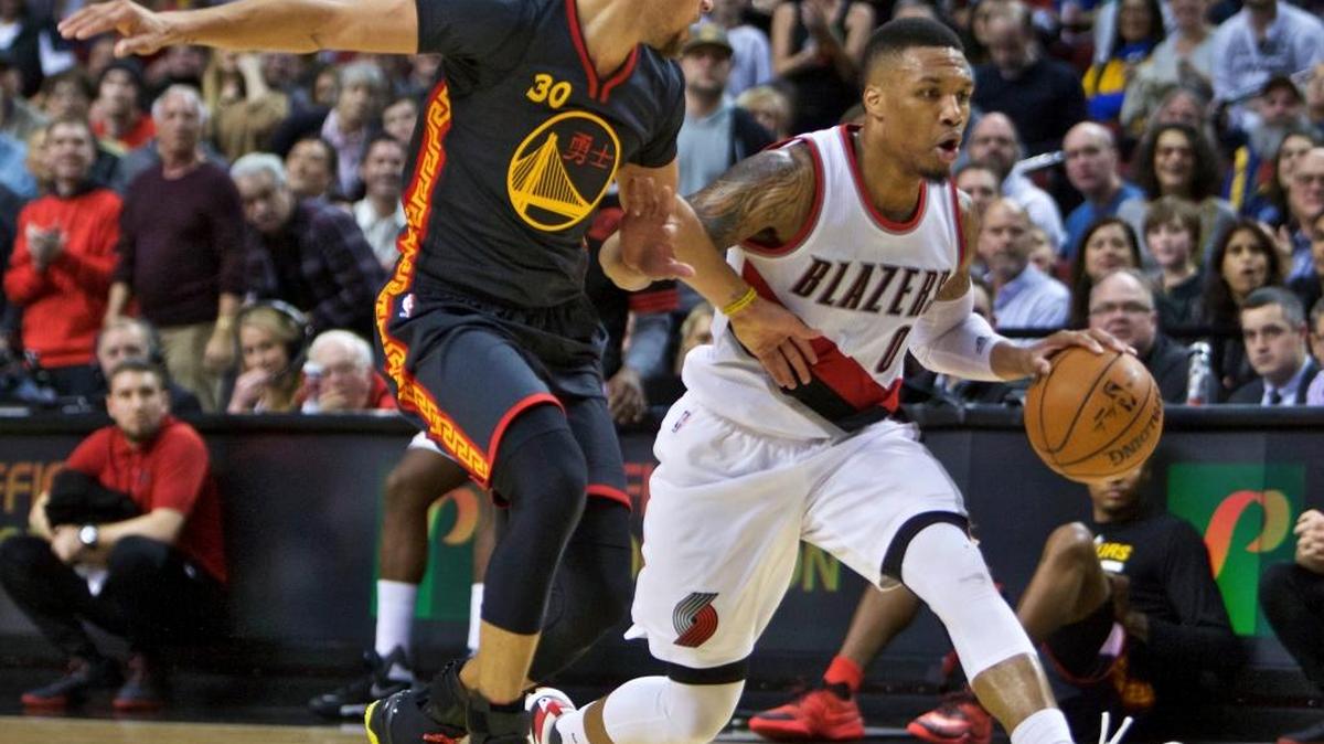 Portland’s Damian Lillard tries to move past the Warriors’ Stephen Curry during the second half in Portland, Ore., Friday, Feb. 19, 2016.