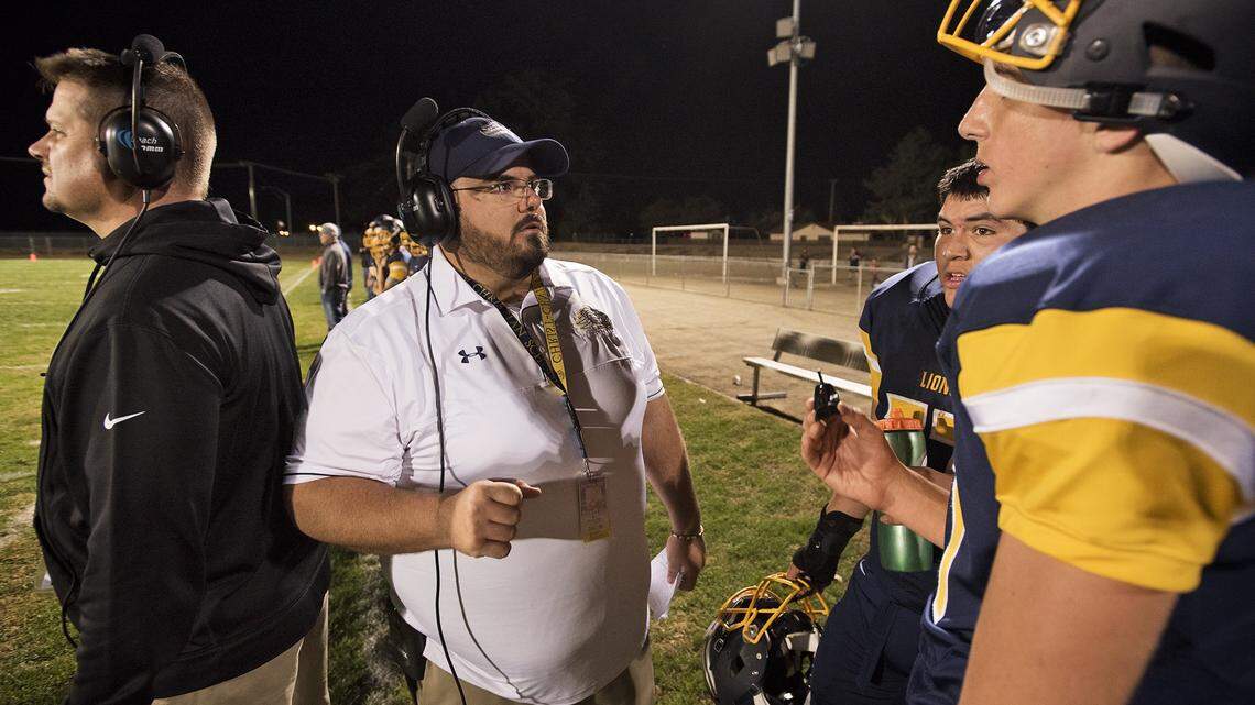 Big Valley head coach Brian Berkefeld talks with players during Friday night's game with Brookside Christian at Big Valley Christian High School in Modesto, Calif., on Friday, Oct. 20, 2017. Big Valley won the game 42-20.