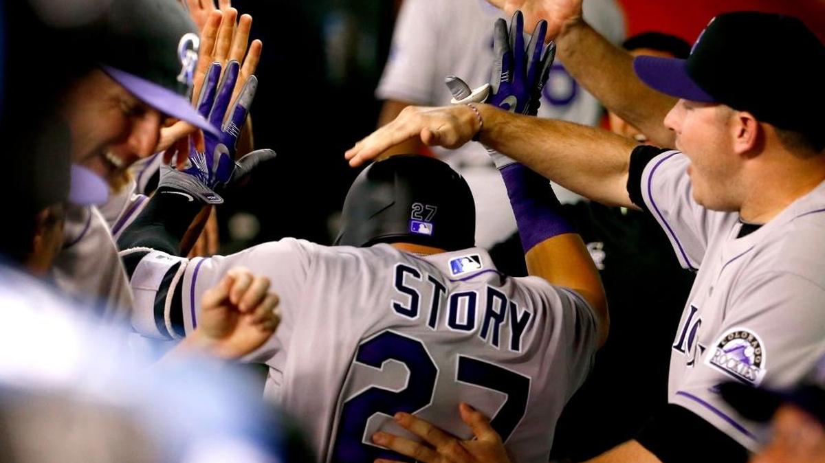 Colorado rookie Trevor Story gets a pat on the head from a teammate in the dugout after homering off Zack Greinke on Monday, April 4, 2016, in Phoenix, Ariz.