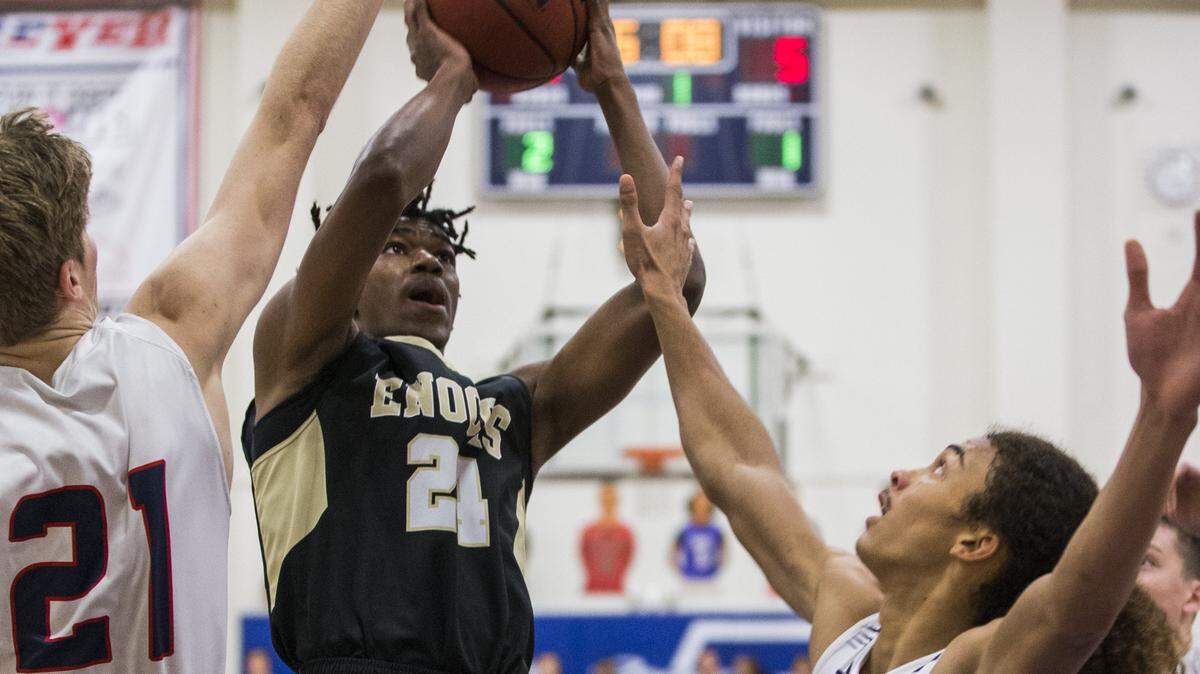 Wesley Williams-Burse(24) of Enochs High soars to the hoop through the Beyer High defense. Enochs High boys basketball traveled to Beyer Wednesday Jan. 10th 2018.