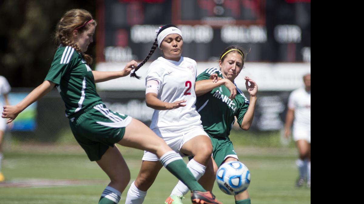 
East Union’s Ilena Rivera cuts through two defenders during the Sac-Joaquin Section Division III final where East Union defeated Manteca 2-0 to win at Lincoln High School in Stockton on Saturday.
