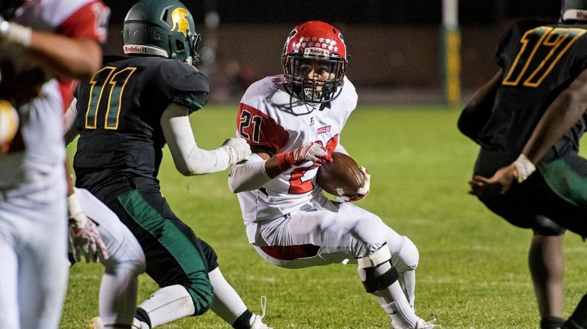 Modesto’s Chris Styles, shown here rushing the ball against Davis, is No. 41 on The Bee’s list of the top-50 returning football players in the Stanislaus District.