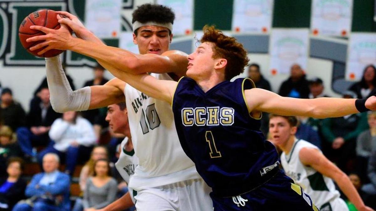 Central Catholic guard (1) Jarred Race reaches for ate steal the ball from Manteca's Tydus Verhoeven (10) during a game between Central Catholic and Manteca at Manteca High School in Manteca, California on January 12, 2017.