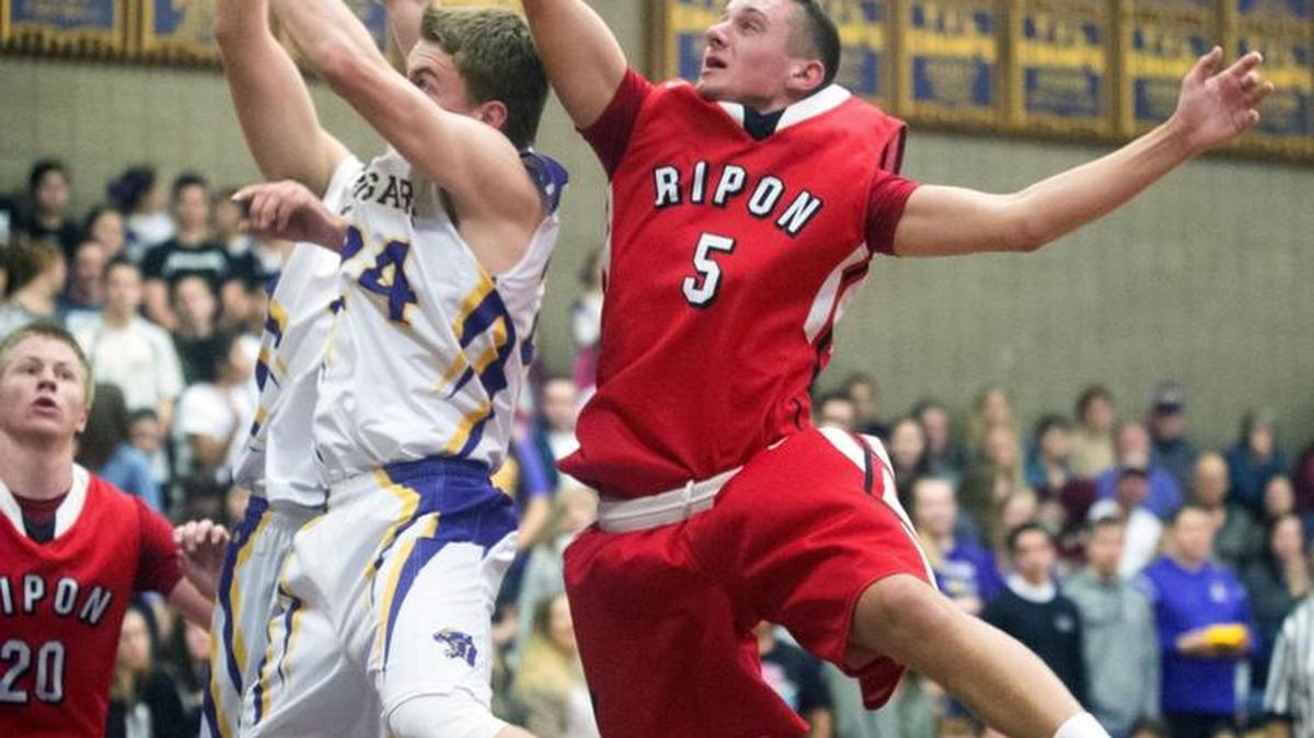 Ripon's Andrew Wood (5) hits the ball away from Escalon's Caleb Hansen (24) during a game between Ripon and Escalon at Escalon High School in Escalon California on February 5, 2016.