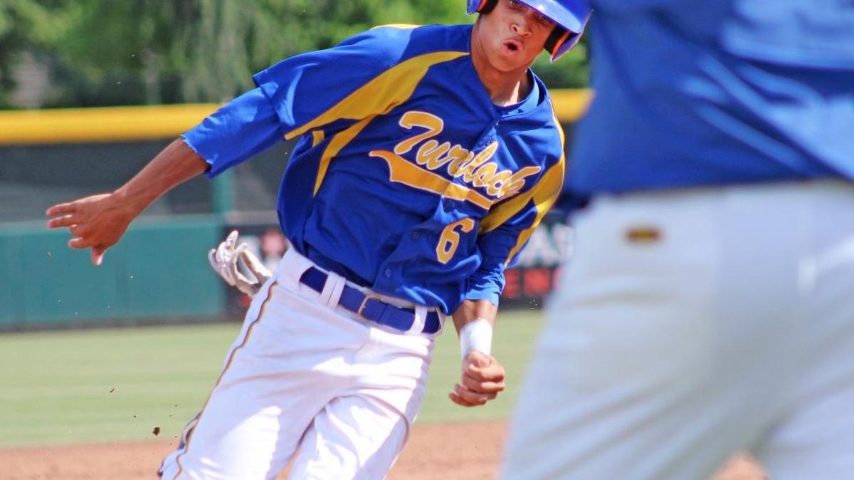 Turlock’s Mitch Pryschuk is waved home by coach Mark de la Motte and scores on Brandon Booz’s single in the first inning against Tracy at Pacific.