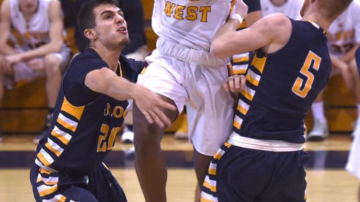Germaun Nutt #25 of Clovis West high school holds onto the ball under heavy defense by Turlock high school players Wednesday December 27, 2017 during the Holiday Hoops Classic tournament at Modesto Christian High School in Salida, Calif.