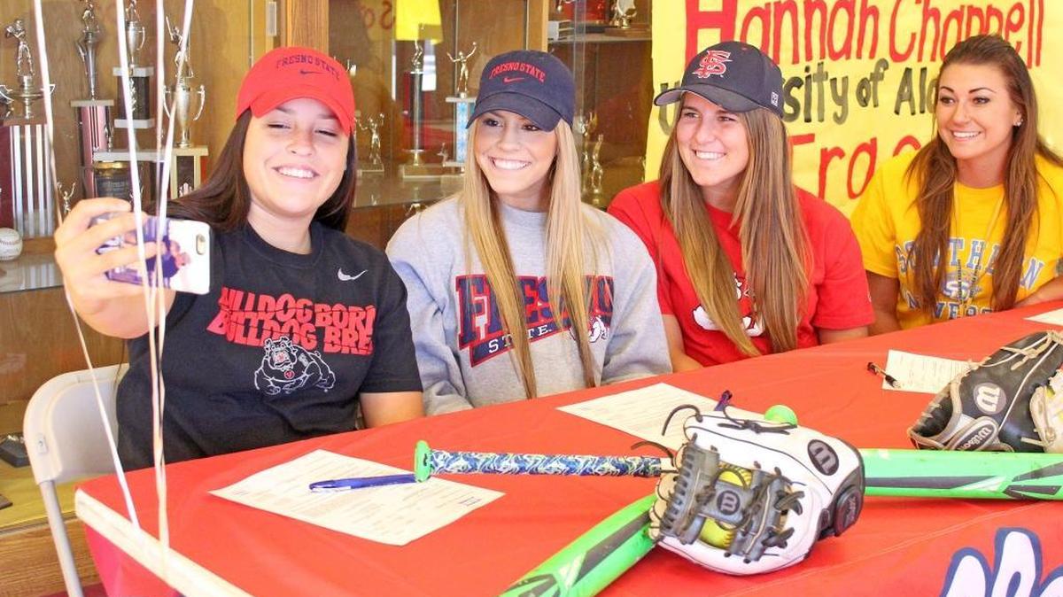 Four players from the Oakdale softball program signed with Division I universities on Thursday, Nov. 12, 2015, in the foyer of the school gymnasium. From left to right: twin sisters Maddi and Kindra Hackbarth, and Haley Fuller signed with Fresno State; while Scarlett Brock signed with Southern University.