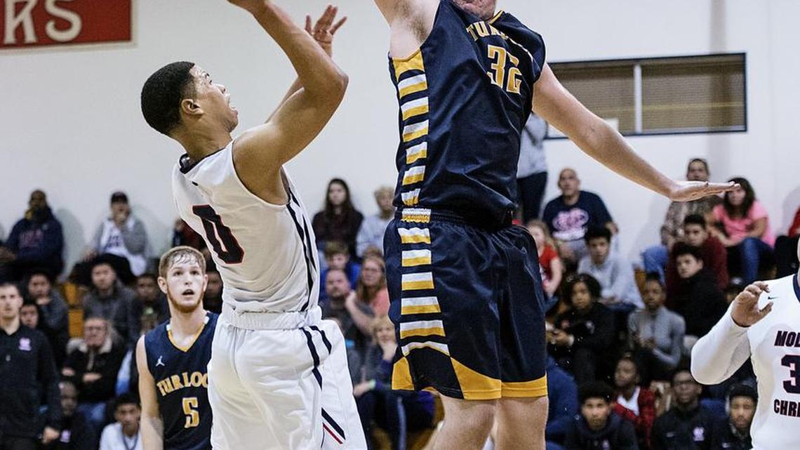 Turlock’s Everett Johnson towers over Darrian Grays as her attempts a shot during the 17th Holiday Hoop Classic game at Modesto Christian High School in Salida, Calif., Wednesday, Dec. 28, 2016.