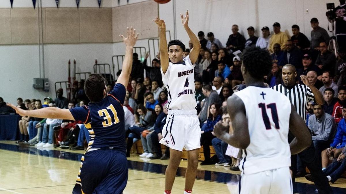 Modesto Christian guard Baljot Sahi sinks a three point shot during the 17th Holiday Hoop Classic game with Turlock at Modesto Christian High School in Salida, Calif., Wednesday, Dec. 28, 2016.