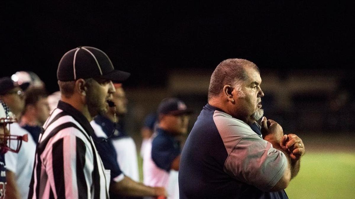 Beyer coach Doug Severe signals a play to his quarterback runs the ball during the non conference game with Tracy at Downey High School in Modesto, Calif., on Thursday, September, 10, 2015.