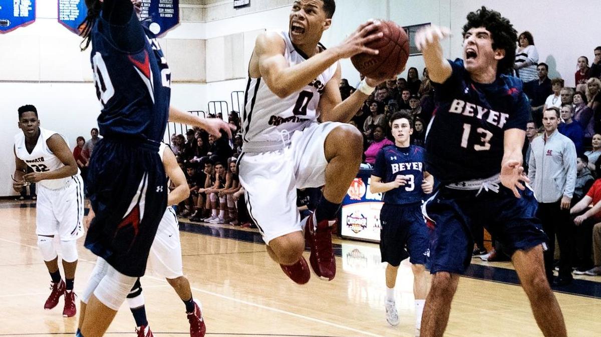 Modesto Christian guard Darrian Grays attempts a layup as Beyer's George Dancer and Brian Perry defend during the Modesto Metro Conference game at Modesto Christian High School in Salida, Calif., on Wednesday, Jan. 20, 2016.