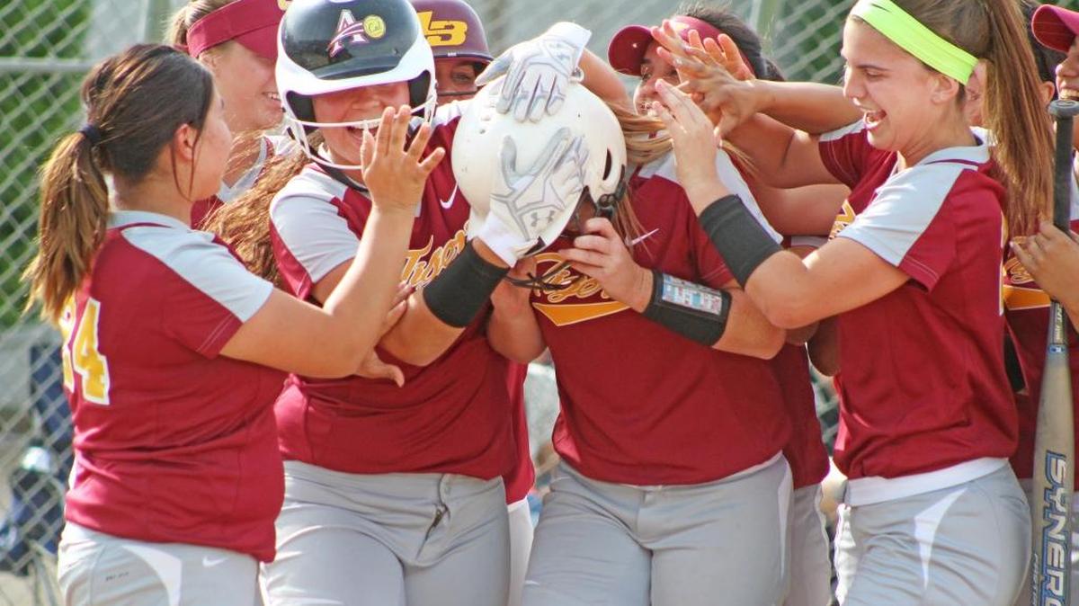 Los Banos junior Ali Waltman, center, is mobbed at home plate by her teammates following a two-run home run in the third inning against Ceres on Tuesday. It was the difference in a 2-1 victory.