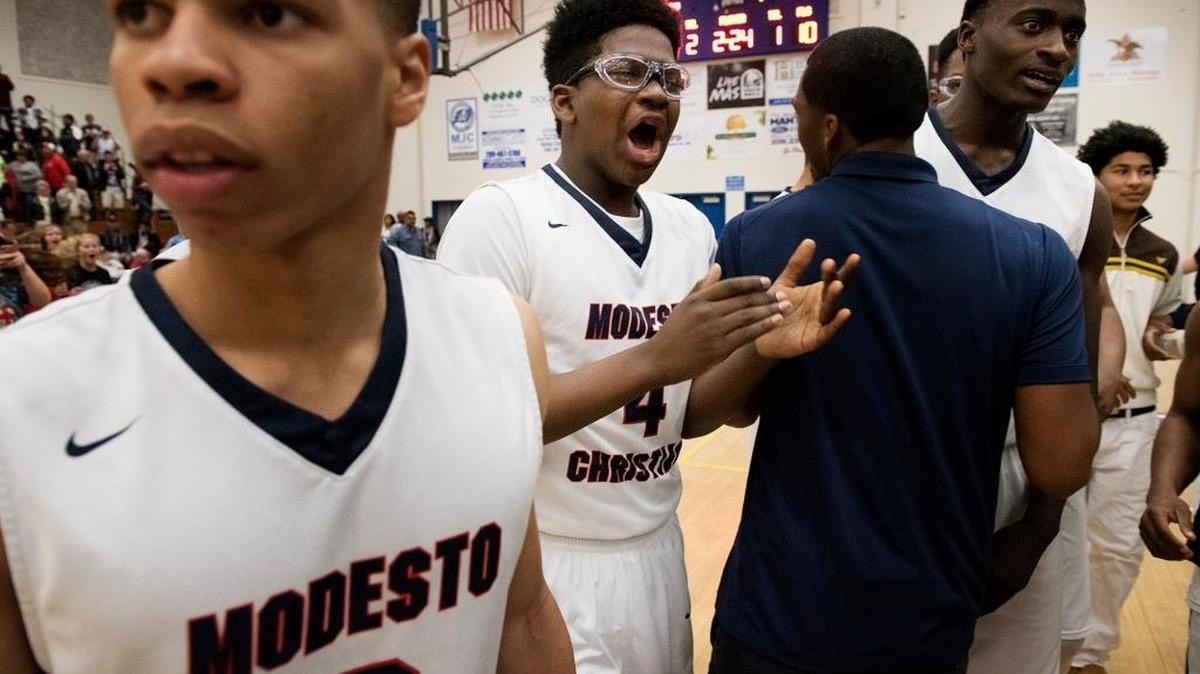 Modesto Christian's, from the left, Darrian Grays, George Murphy (4) and Robinson Idehen (23) leave the court after their 61-49 victory over Sheldon during the CIF Northern California Open Division boys semifinal game at Modesto Junior College in Modesto, Calif., on Tuesday, March, 15, 2016.