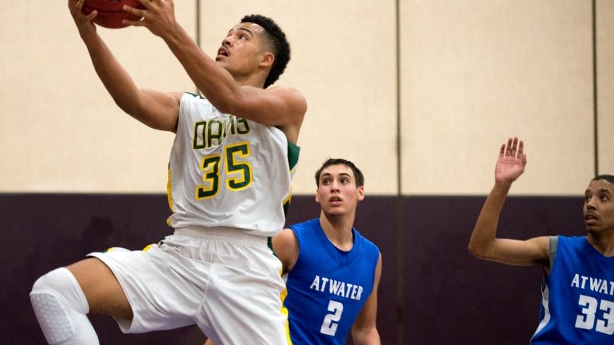 Grace Davis’ Talolo Limu-Jones breaks past Atwater’s Kyle Anaya (2) and Reggie Ricks (33) for a layup during the Modesto City Classic at Johansen High School in Modesto a year ago.