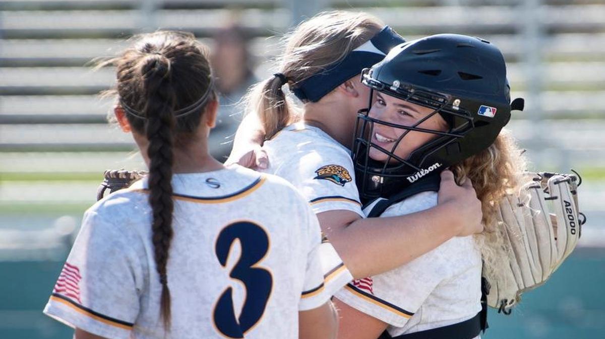 Gregori catcher Mehana Johns hugs pitcher McKyla Nelson after an inning ending strike out during the Modesto Metro Conference game with Downey in Salida, Calif., on Tuesday, March 28, 2017.