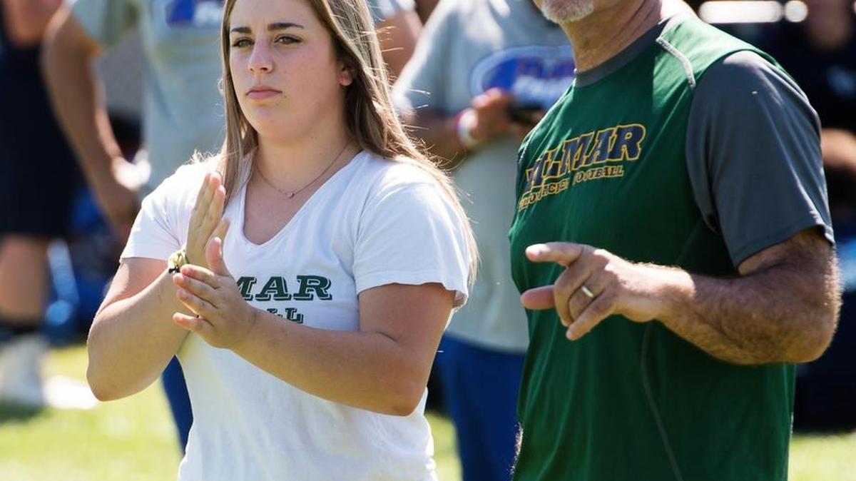 Junior Morgan Amarante signals the offensive plays for Hilmar coach Frank Marques, right, during the 11th annual MJC Passing Tournament at Modesto Junior College in Modesto, Calif., on Saturday, July 8, 2017.