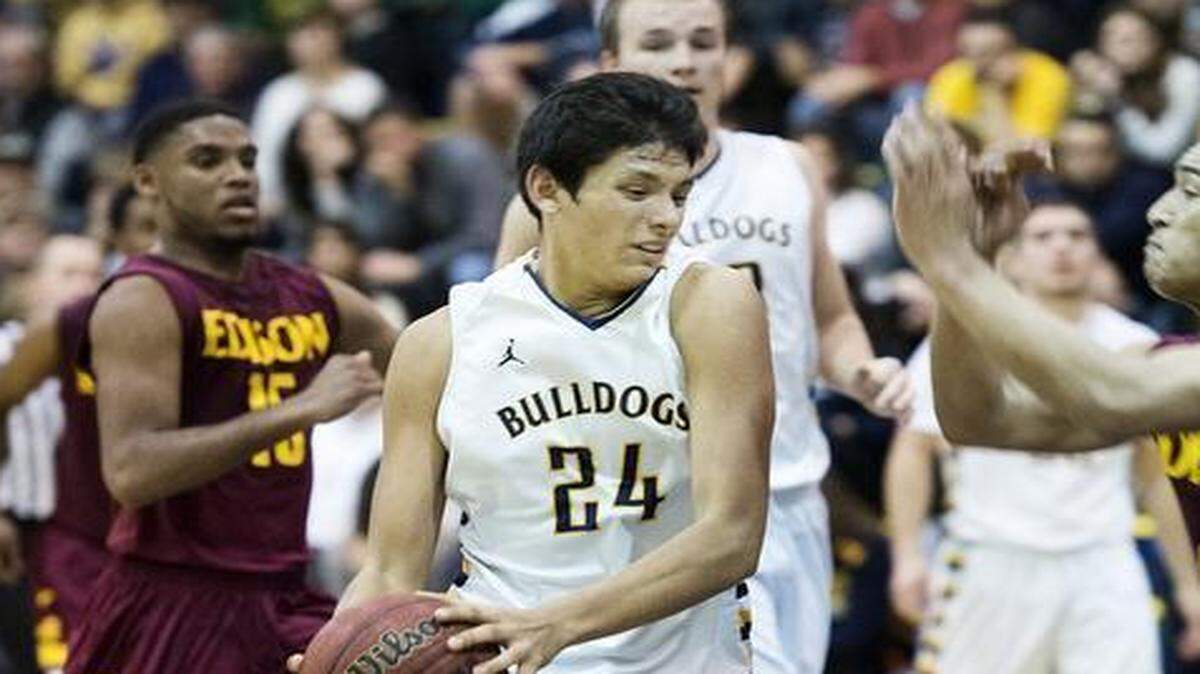 
Turlock High’s Habib Velasquez drives the ball on Edison defenders during the Sac-Joaquin Section playoff game in Turlock, Calif., on Friday, February, 20, 2015. Turlock won the game 60-47. 
