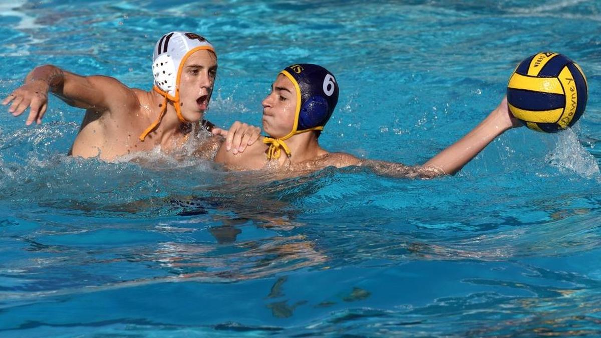 Gregori high school’s Ethan Wetzel prepares to throw the ball as he is guarded by Golden West’s Zach Timmer Friday morning (10-21-16) during the DeLong water polo tournament at Downey High School in Modesto, Calif.