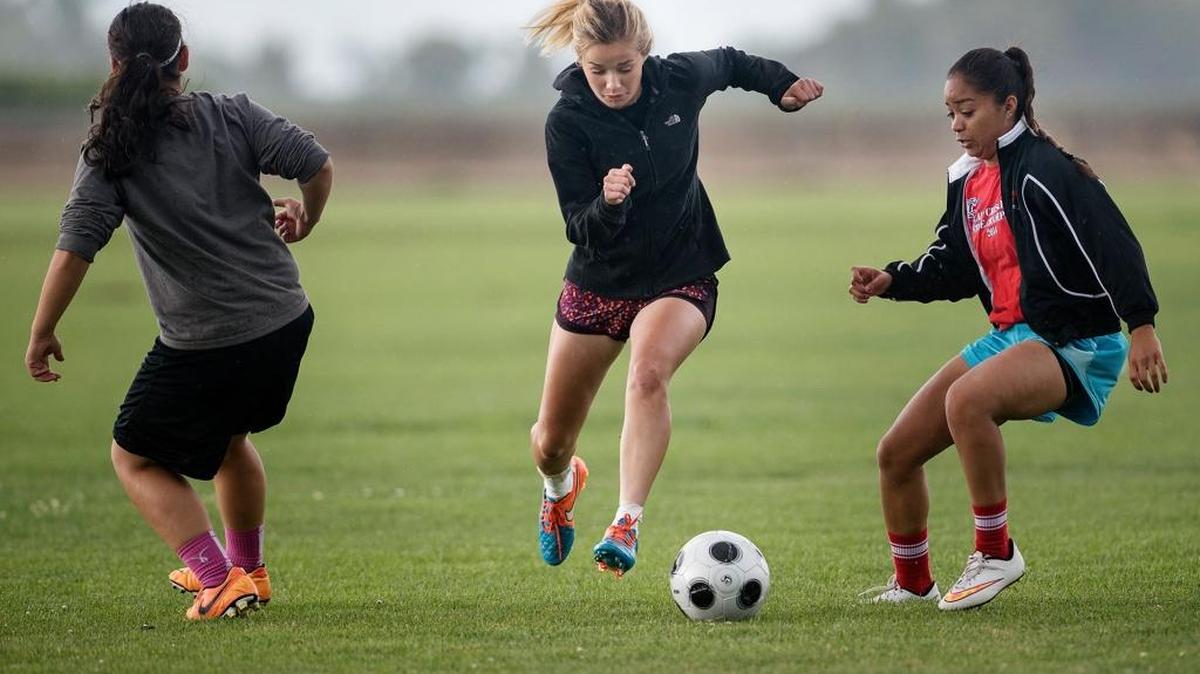 Modesto Christian’s Carsyn Hoogendoorn, middle, slips past teammates Ashley Lucas, right, and A.J. Ovando, left, in a May 14, 2015 practice in Salida.