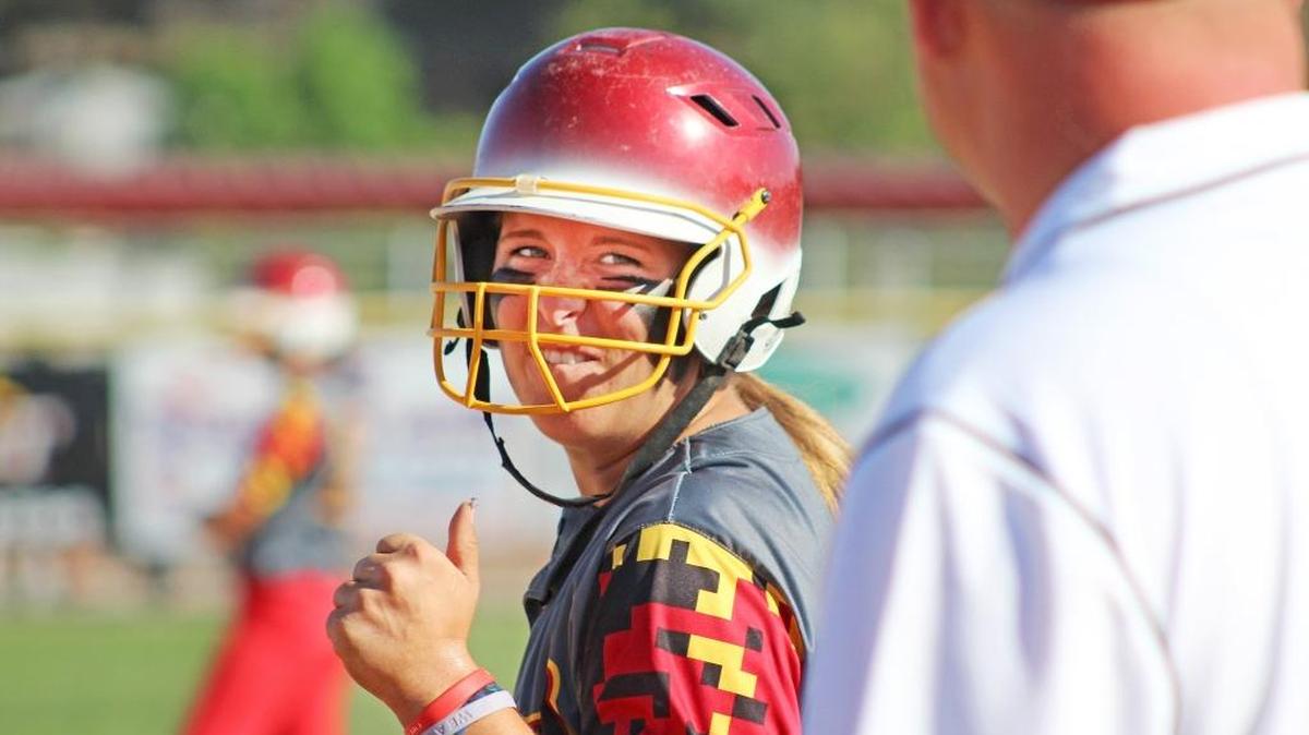 Oakdale senior shortstop Haley Fuller talks to her first-base coach after reaching base during a 1-0 victory over East Union on Tuesday, May 10, 2016, at Oakdale High School. With a single, Fuller extended her hitting streak to 17 games.