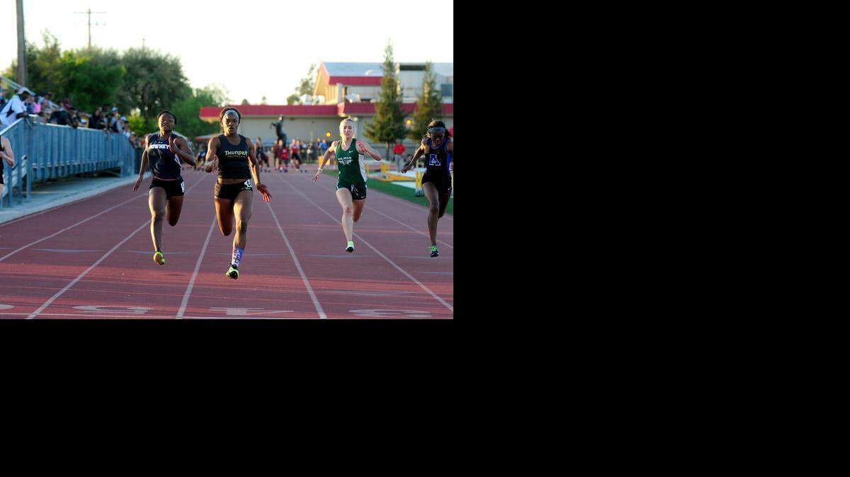 Buhach Colony’s Brandy Coward, second from left, approaches the finish line to win the 100 in a time of 12.29 over runner-up Erykah Hall, left, of Downey. Coward went on to double in the 200.