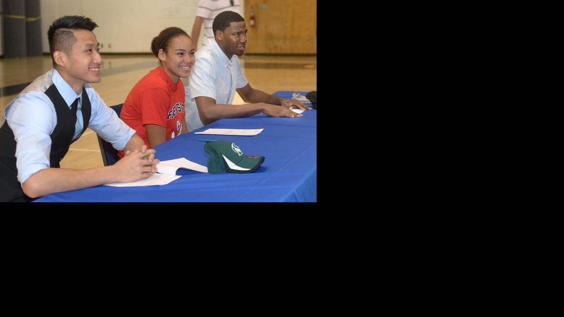 
Jeff Wu, Candice White, and Anthony Townes signed their letters of intent to attend Division I colleges before an enthusiastic crowd of parents, students, coaches and staff at Modesto Christian, Nov. 12, 2014.
