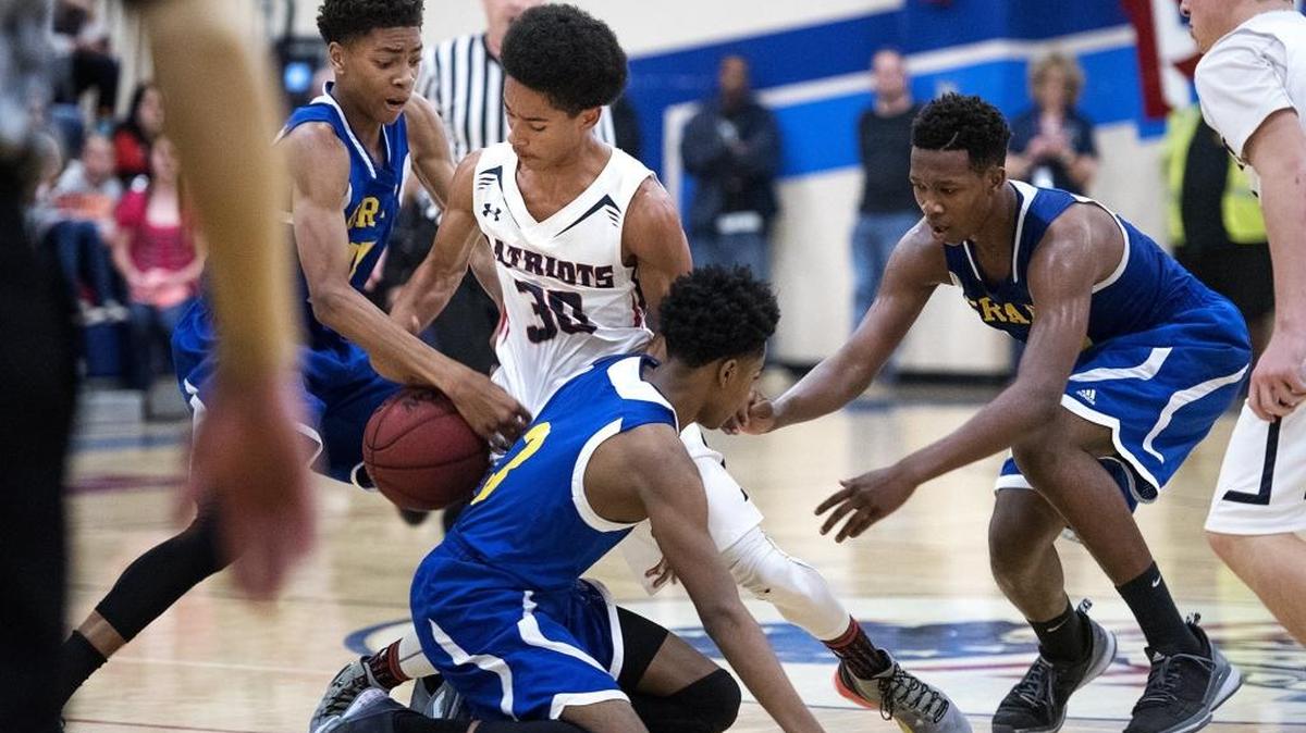 Beyer guard Jaden Cobb gets tangled up with Grant players during the Sac-Joaquin Section Division II playoff game at Beyer High School in Modesto, Calif., on Wednesday, Feb. 24, 2016. Grant won the game 80-72.
