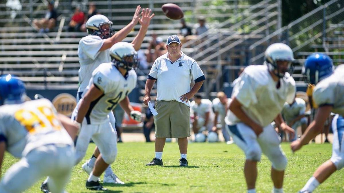 Central Catholic football coach Roger Canepa watches his offense scrimmage during the Central Catholic football camp in Modesto, Calif., Saturday, July 19, 2014.