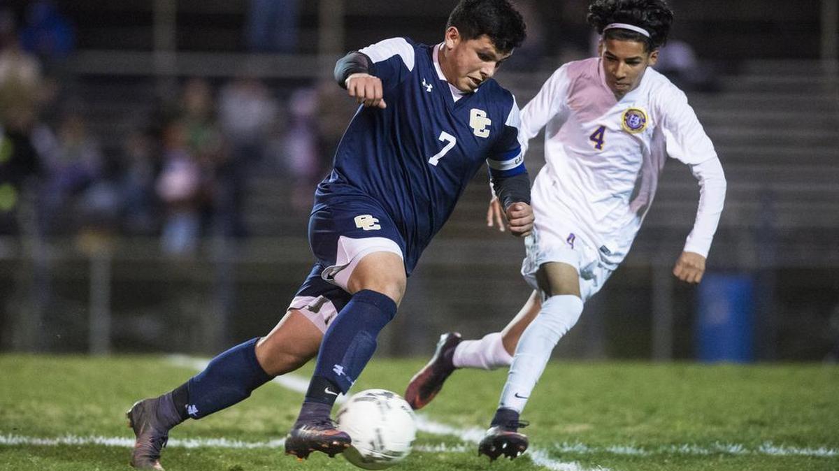 Central Catholic senior Robert Mejia (7) attempts to get past Livingston sophomore Julian Cabrera (4) during a Sac-Joaquin Section Division IV playoff game at Livingston High School in Livingston, Calif., on Thursday, Feb. 23, 2017. The Wolves beat the Raiders 1-0.