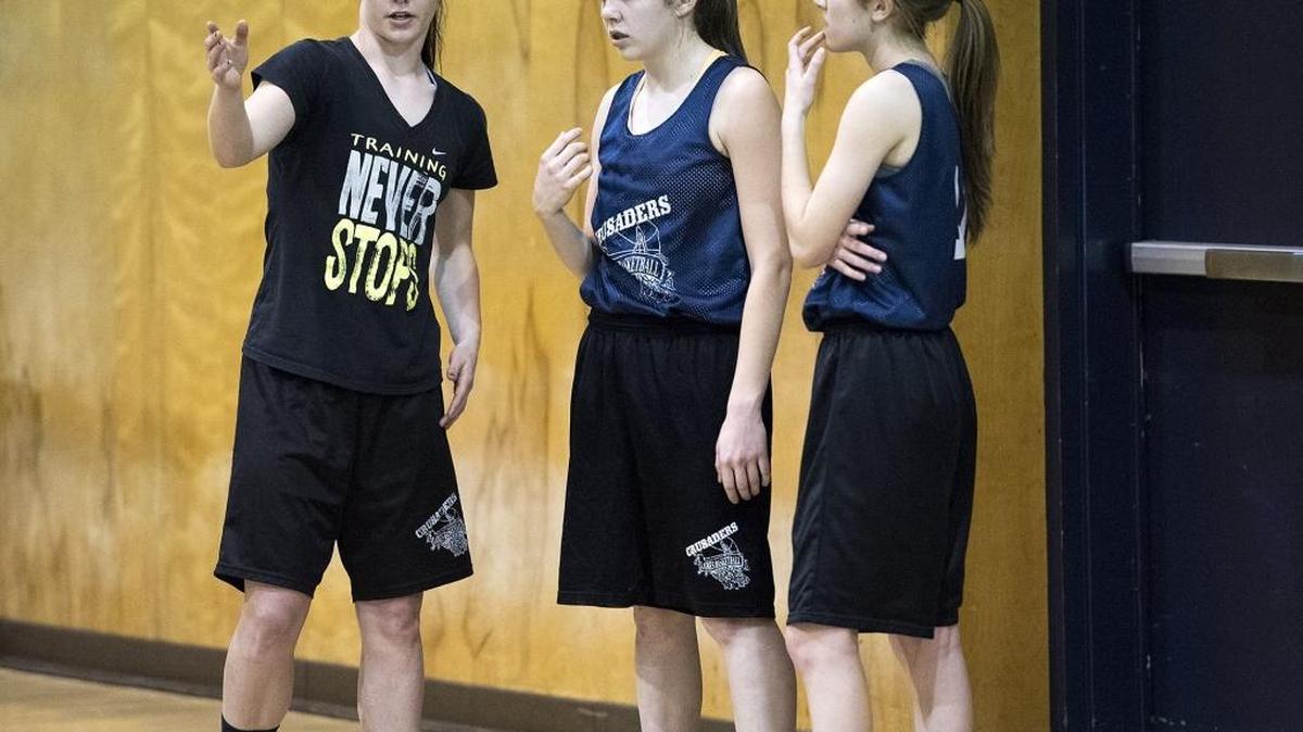 Modesto Christian guard Meagan Warwick gives some pointers to freshmen players Courtney Six, middle, and Allison Tilbury, right, during practice in Salida, Calif., on Monday, Feb. 22, 2016.