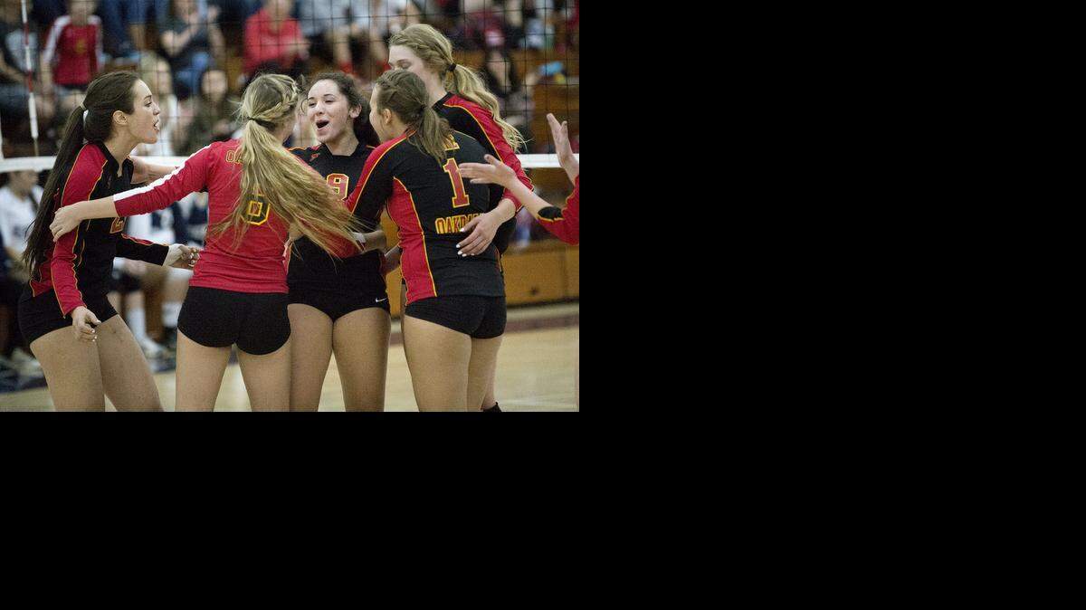 
Oakdale High’s Stephanie Kupper, center, celebrates her kill shot with teammates during the Mustangs’ Valley Oak League title-clinching victory against Central Catholic. 
