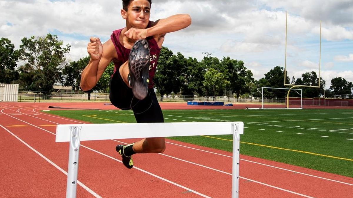 Golden Valley High School’s Shawn Bettencourt jumps over a hurdle at Golden Valley High School in Merced, Calif., on Friday, June 9, 2017. Bettencourt is the Boys Track Athlete of the Year.
