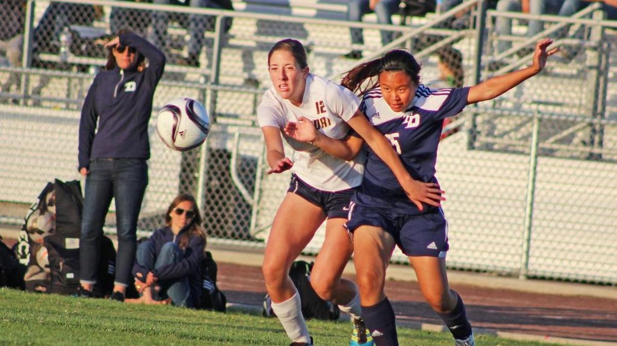 Downey defender Isabella Mendez (right) and Gregori forward Chelsey Rios battle for a loose ball during the first half of a Modesto Metro Conference game on Wednesday, April 13, 2016, at Don Lanphear Stadium.