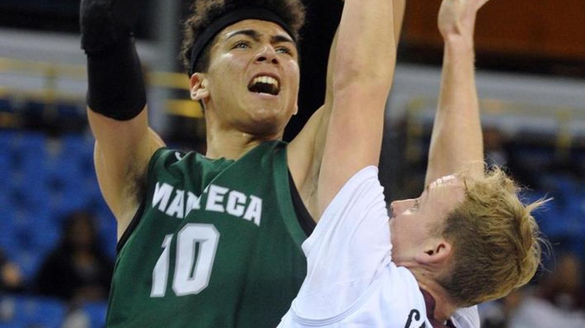 Manteca’s Tydus Verhoeven scores over Weston Ranch’s Fred Lavender during the first half of the Sac-Joaquin Section Division III Championship game this month at Sleep Train Arena in Sacramento.