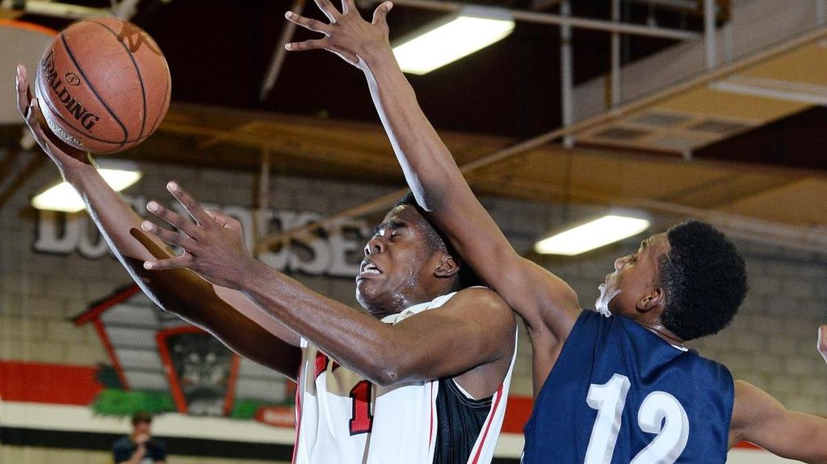 Ayala's Austen Awosika (1) drives past Redlands Davonte Carrier (12) to score during the first half Wednesday night in Chino Hills. Ayala hosted Redlands in a first round CIF boys basketball playoff game Wednesday February 17, 2016 in Chino Hills. (Will Lester/Inland Valley Daily Bulletin)