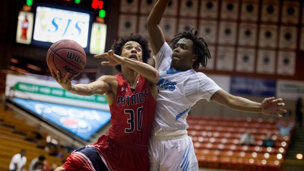 Beyer Patriots guard Jaden Cobb (30) sores a basket in front of Burbank Titans’ Earvin Knox (5) in the second half in the D ll Sac-Joaquin Section Semi-Final Championship game between Burbank and Beyer on Wednesday March 1, 2017 in Stockton.