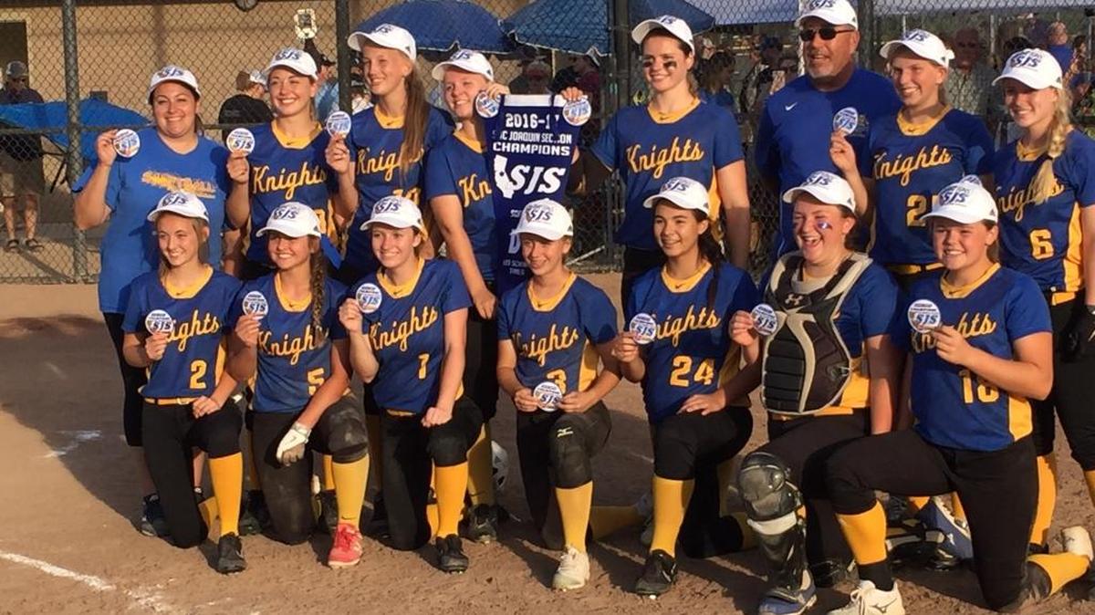 The Ripon Christian High School softball team poses for pictures with the blue section banner after defeating Stone Ridge Chrisitan 13-3 in the Sac-Joaquin Section Division VII championship game on Wednesday, May, 24, 2017 at the Arnaiz Softball Complex in Stockton.
