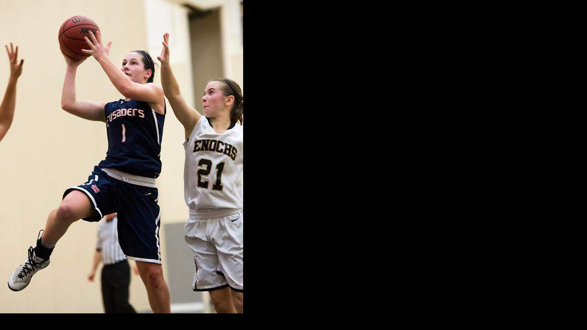 
Modesto Christian guard Nicole Warwick drives past Enochs guard Katie Dillon for two points in Tuesday’s game at Enochs. 


