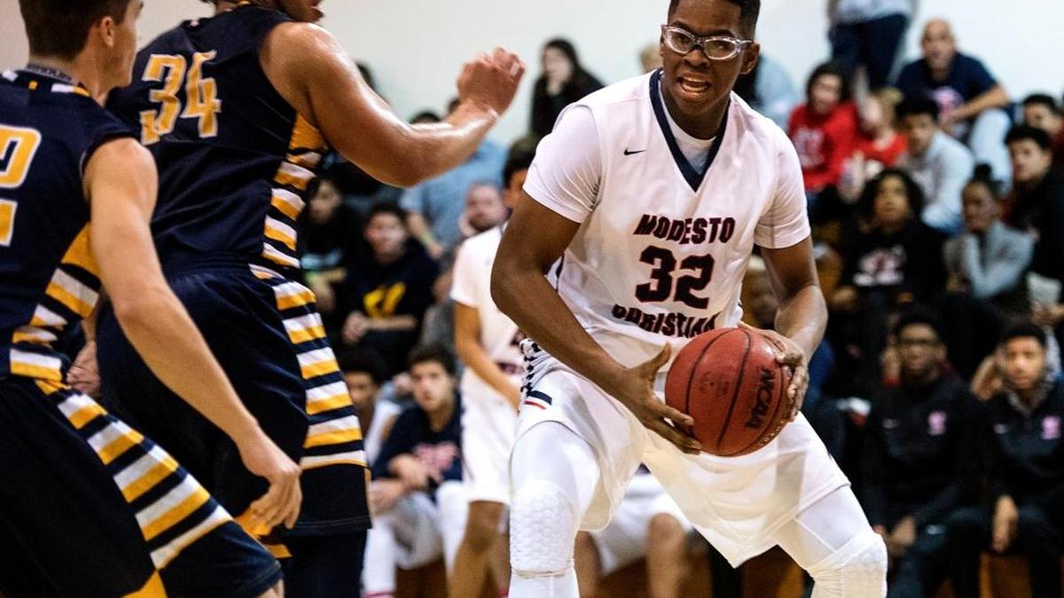 Modesto Christian center Gabe Murphy (32), shown here competing against Turlock at the 17th Holiday Hoop Classic game, signed a letter of intent to play basketball and continue his studies at Northwest Nazarene University in Idaho.