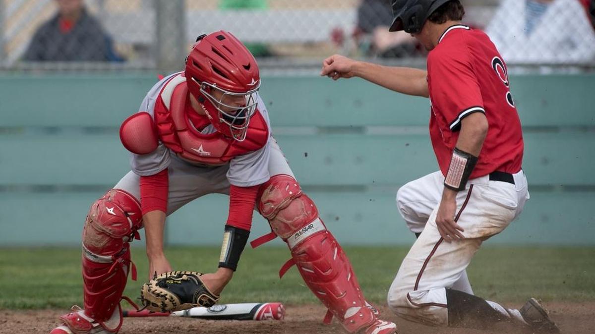 Modesto’s Max McCabe scores past Oakdale catcher Bryce Kirk to tie the game in the 7th inning during the Pedretti Tournament game at Modesto High School in Modesto, Calif., on Wednesday, March. 8, 2016.